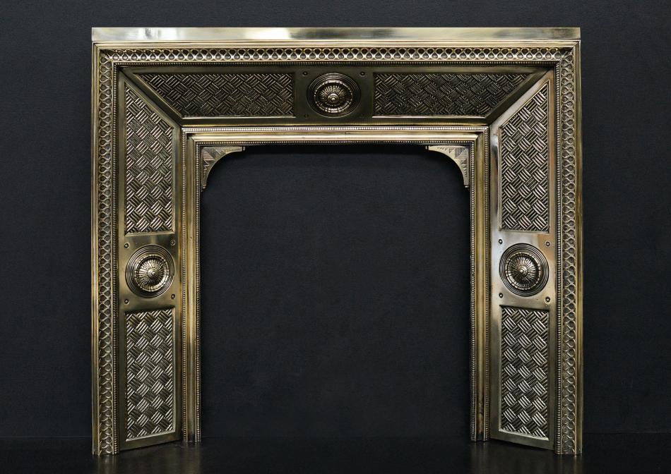 A decorative brass fireplace insert