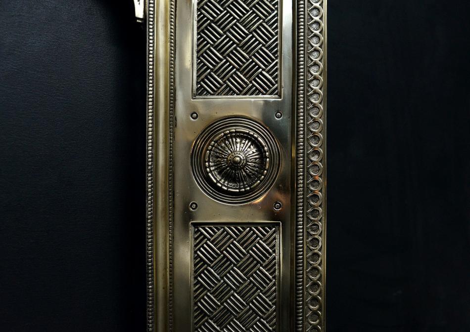 A decorative brass fireplace insert