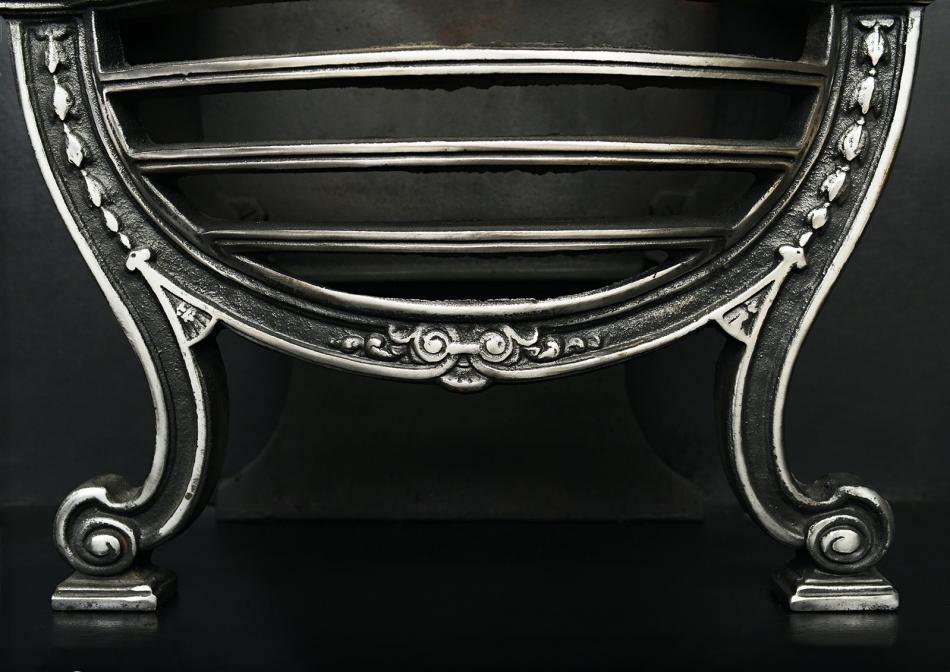 A polished cast iron Adam style basket