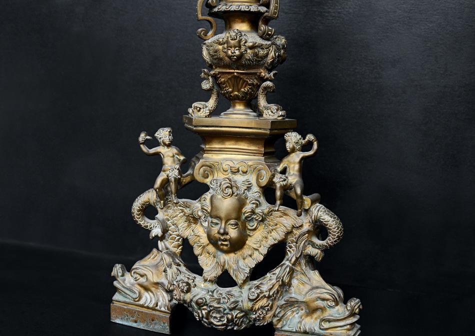 An ornate pair of brass firedogs