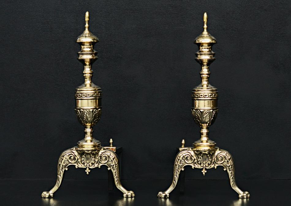 A pair of Regency style brass firedogs