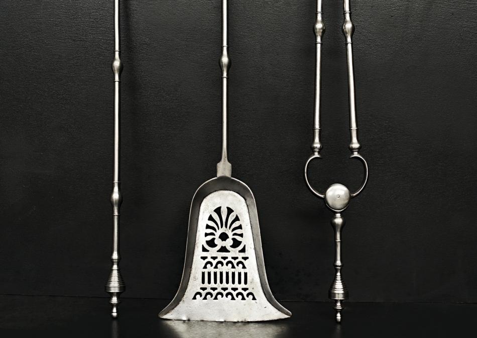 A set of polished steel firetools in the Georgian manner