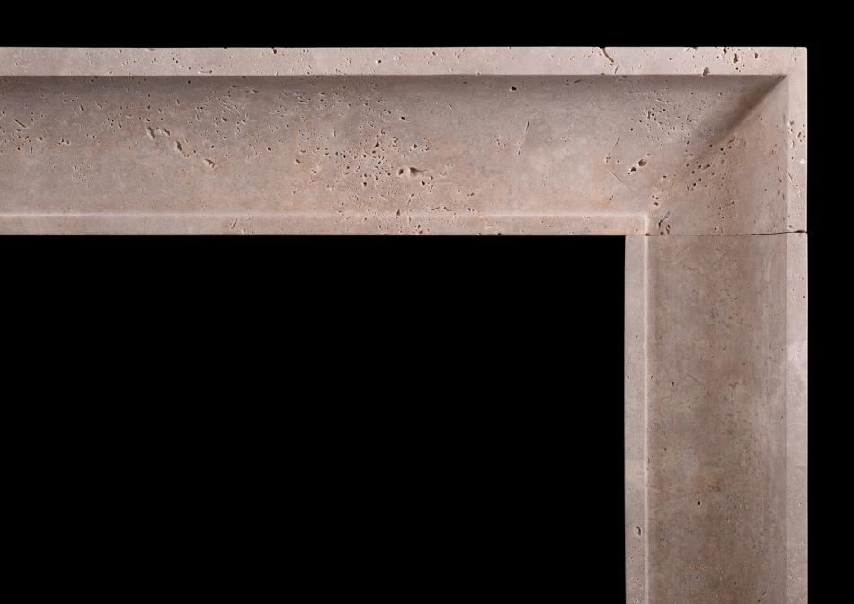 A small architectural fireplace in Travertine stone