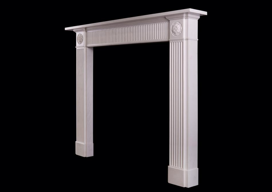 A white marble fireplace in the Regency style