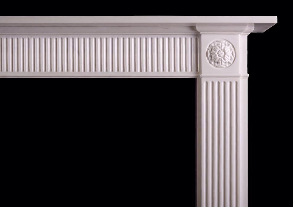 A white marble fireplace in the Regency style