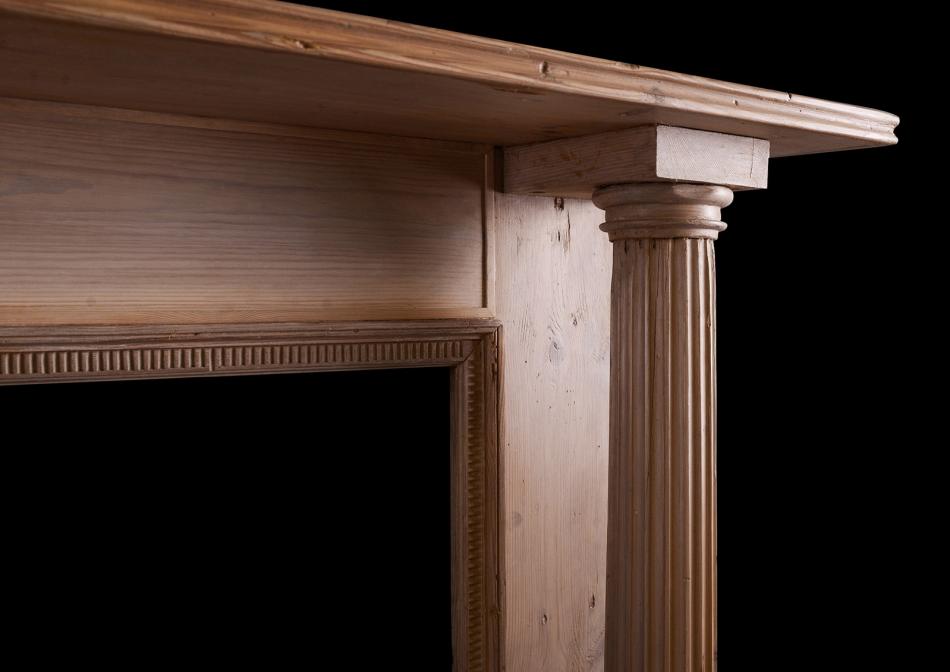 A columned pine fireplace in the Georgian manner