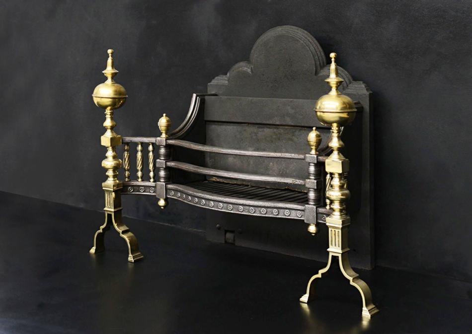 A decorative brass and steel firegrate