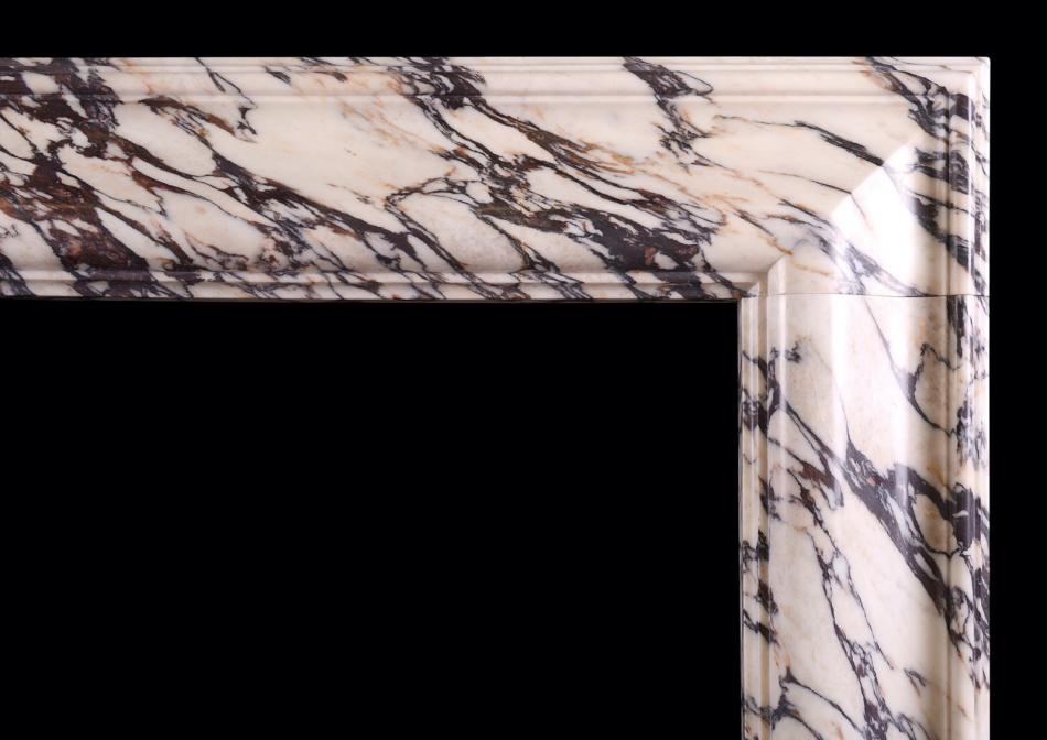 A bolection fireplace in fine quality Breche Violette marble