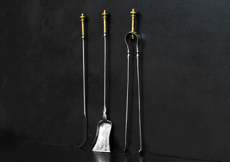 A set of brass and steel firetools.