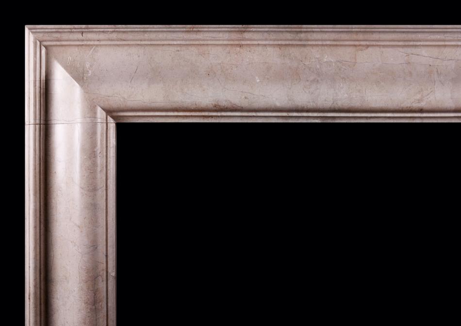 A bolection fireplace in Crema Marfil marble