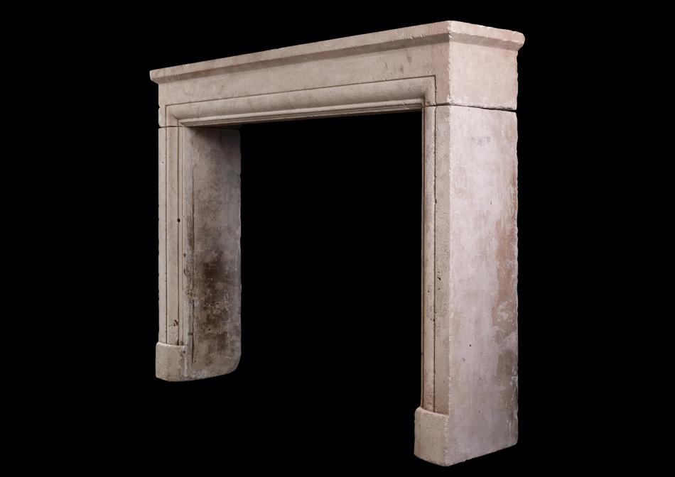 AN ARCHITECTURAL STONE FIREPLACE