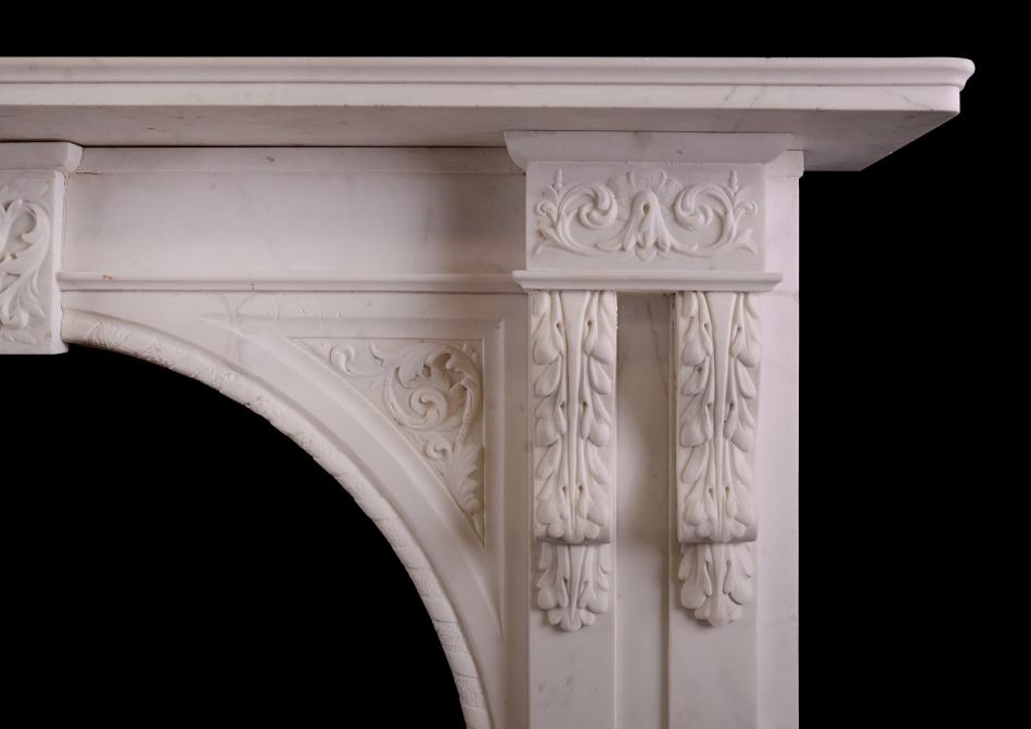 A carved arched marble fireplace