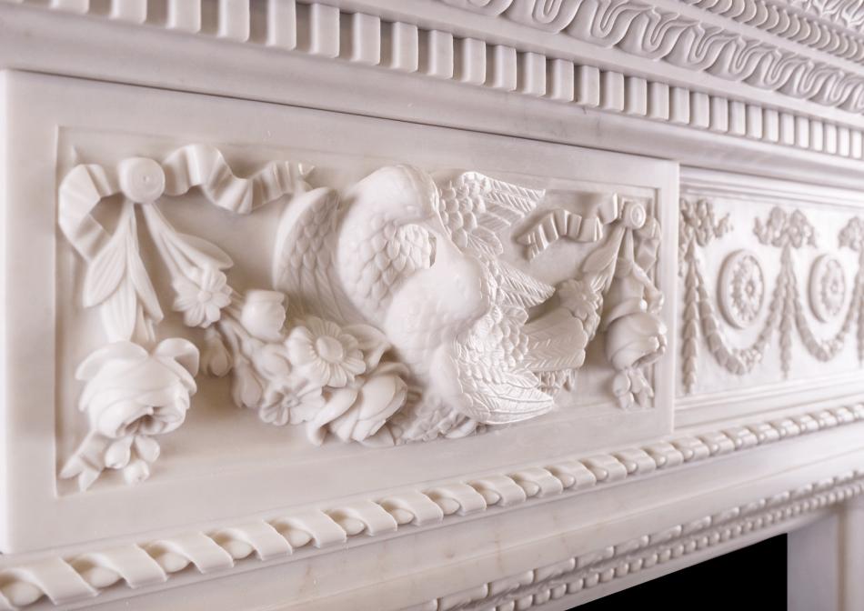 A FINELY CARVED MARBLE FIREPLACE