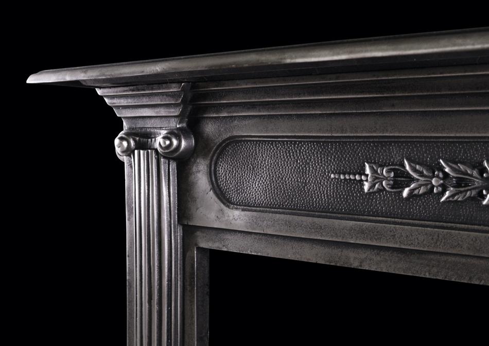 A polished cast iron fireplace in the classical style