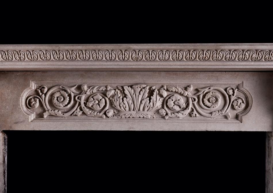 A carved English stone fireplace