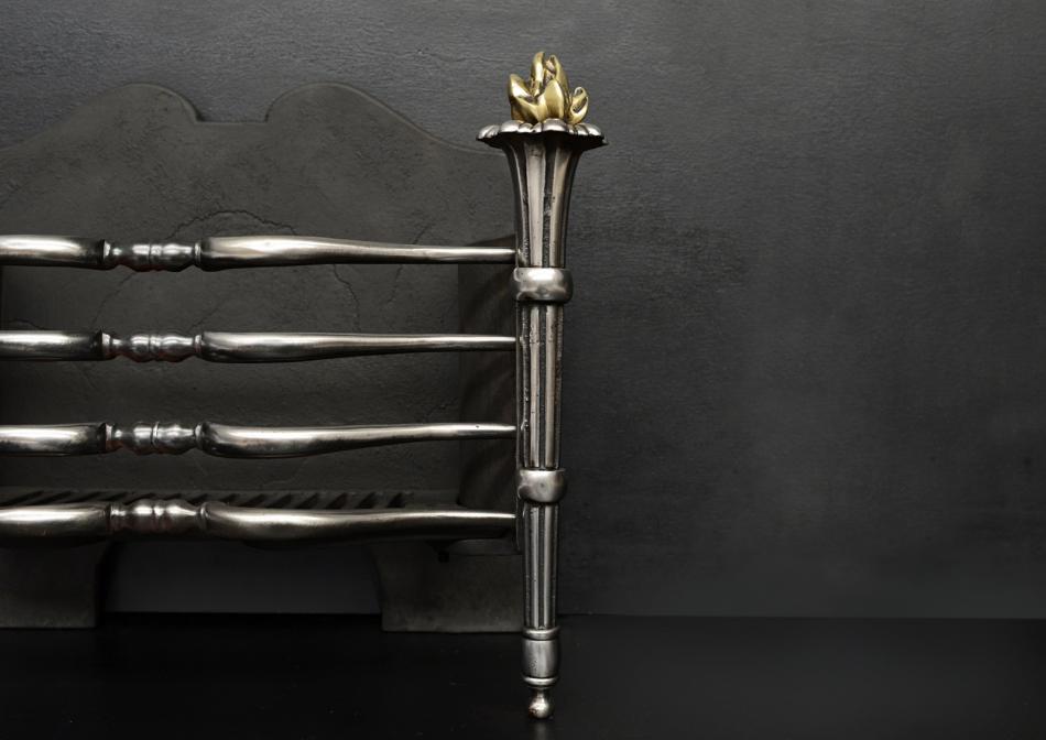 A brass and steel torch firegrate
