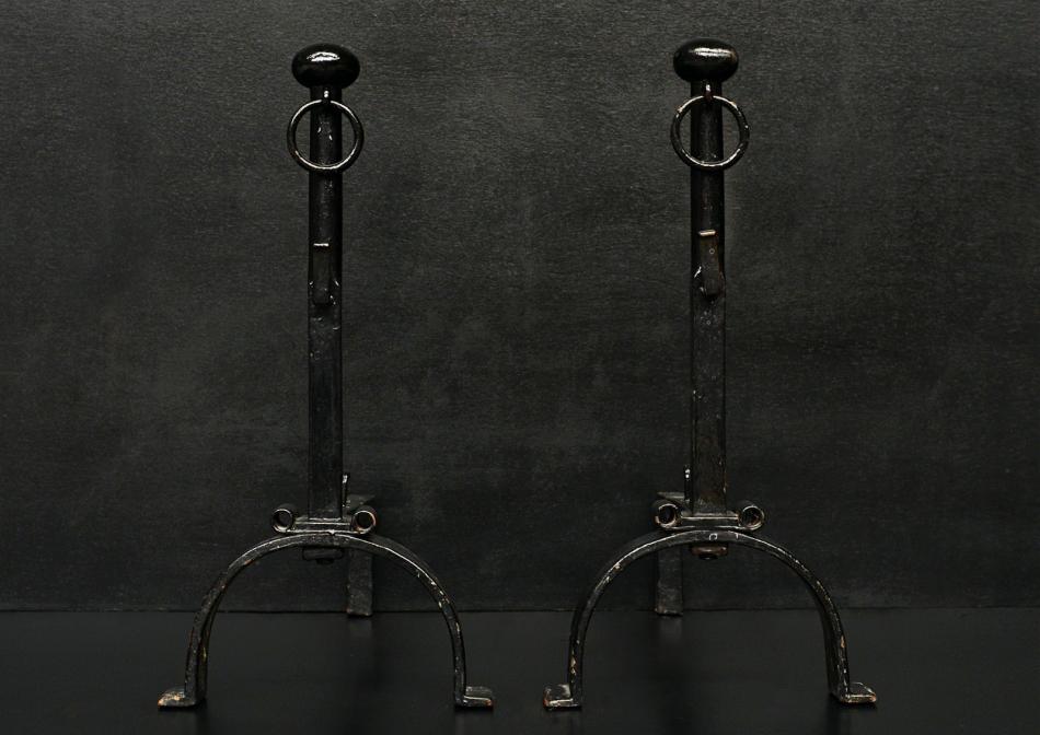 A pair of black wrought iron firedogs