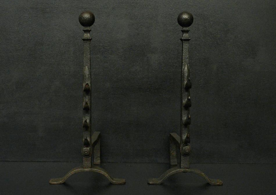 A pair of iron firedogs with ball tops