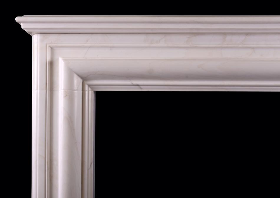 An English bolection fireplace in white marble