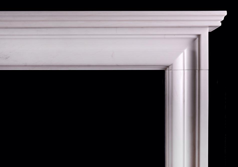 An English moulded bolection fireplace in white marble