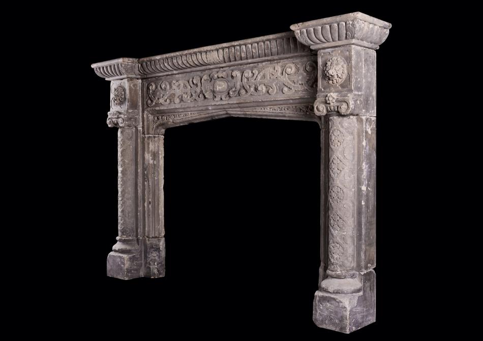 A rustic Neo-Gothic stone fireplace