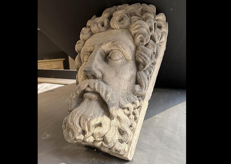 A cast stone bust of the Greek god Zeus