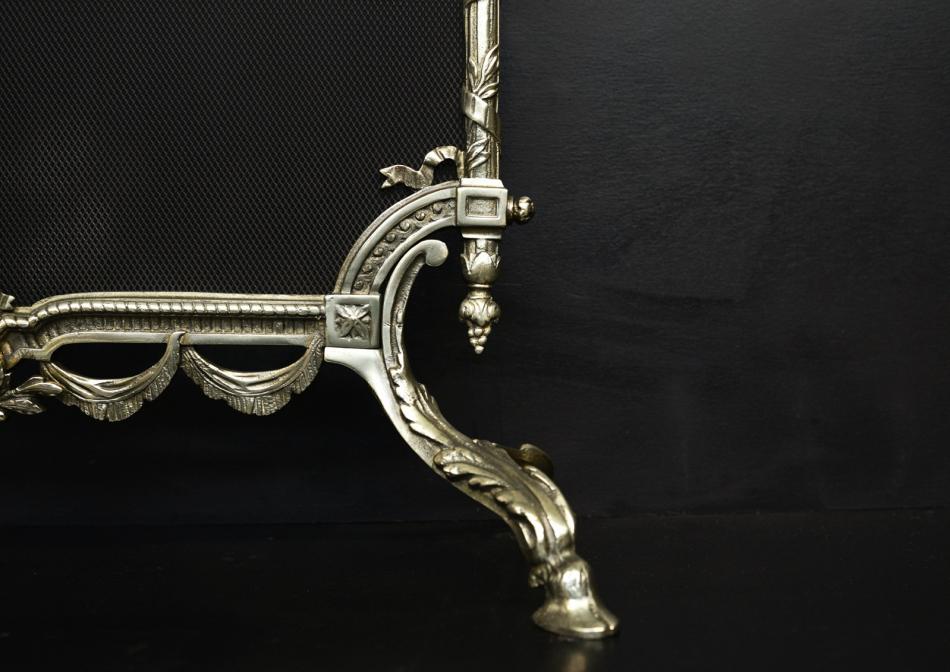 A decorative brass fireguard in the Regency style