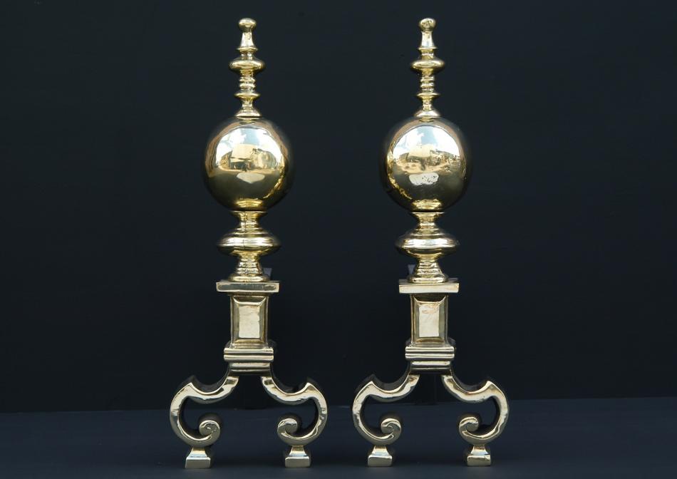 A pair of brass firedogs with ball finials