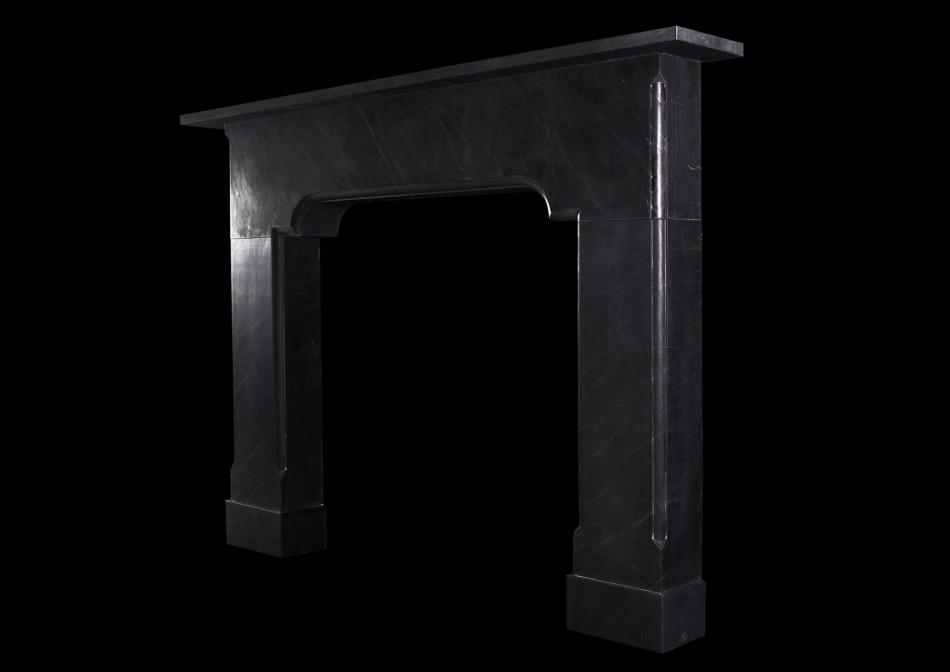 An imposing architectural black marble fireplace