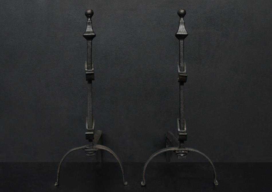 A pair of wrought iron firedogs