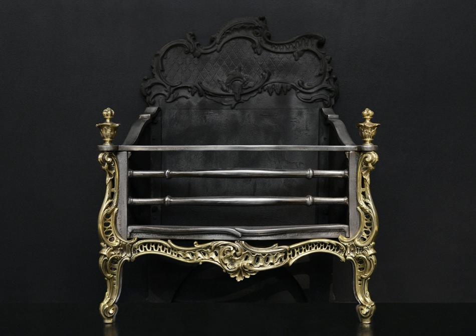 An attractive Rococo brass and steel fire grate