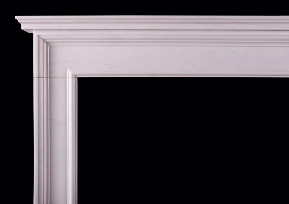 An architectural fireplace in white marble