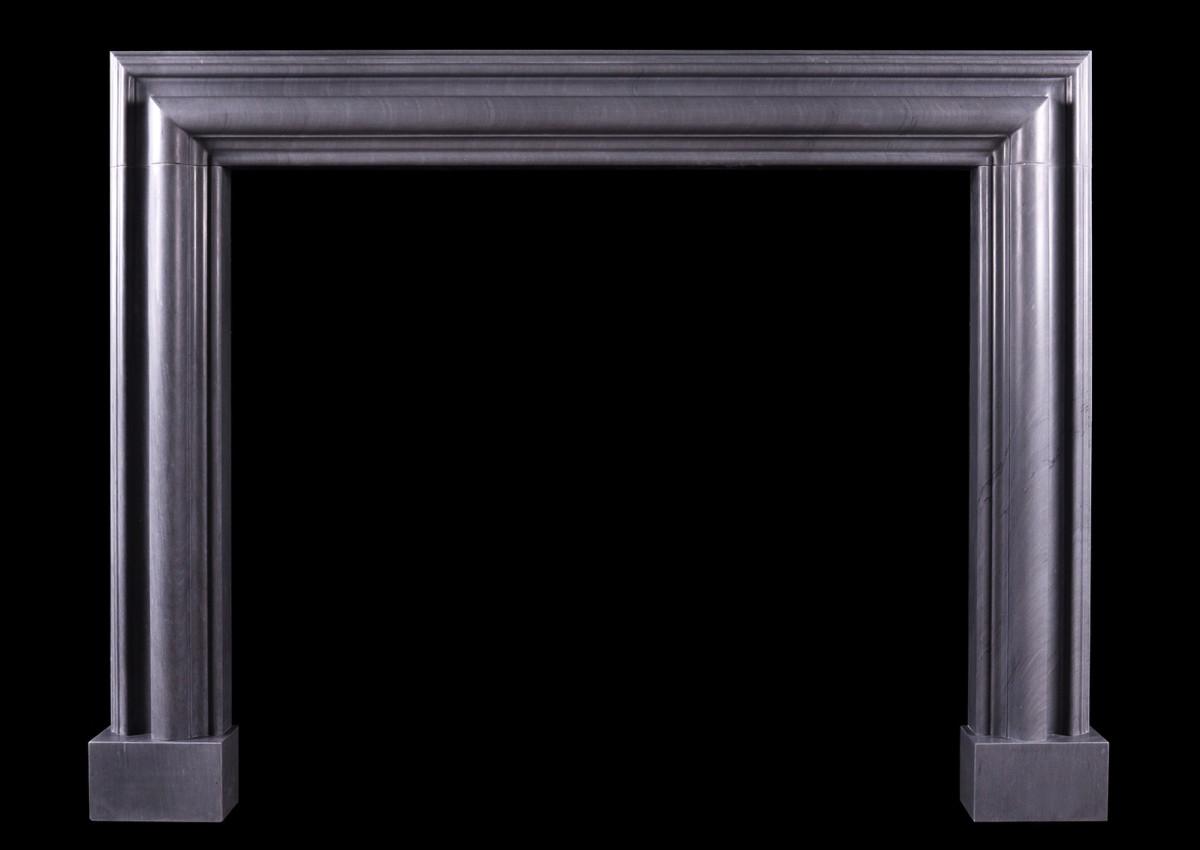 A bolection fireplace in Italian Bardiglio grey marble