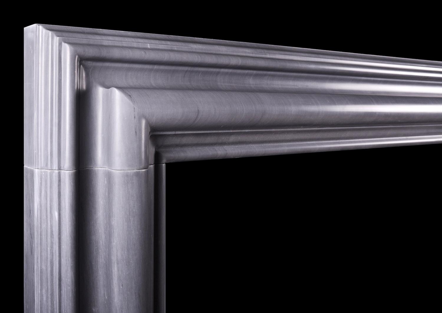 A bolection fireplace in Italian Bardiglio grey marble