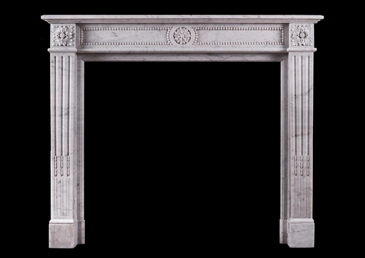 A petite French marble fireplace in the Louis XVI manner