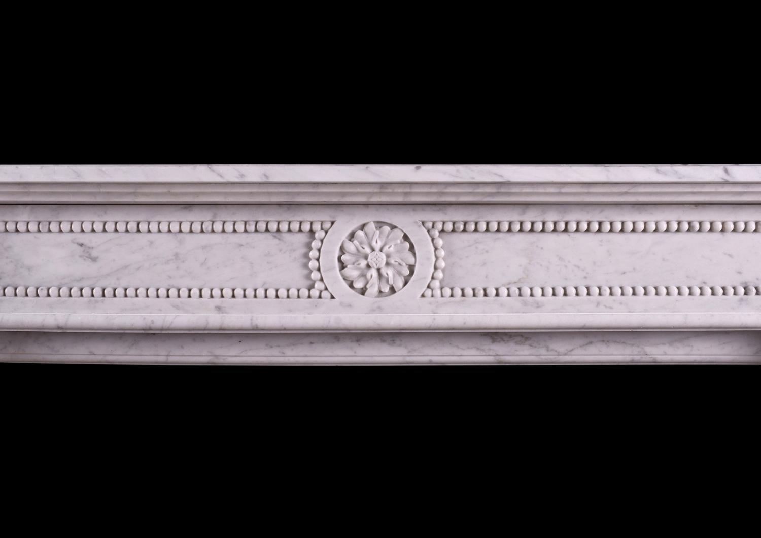 A petite French marble fireplace in the Louis XVI manner