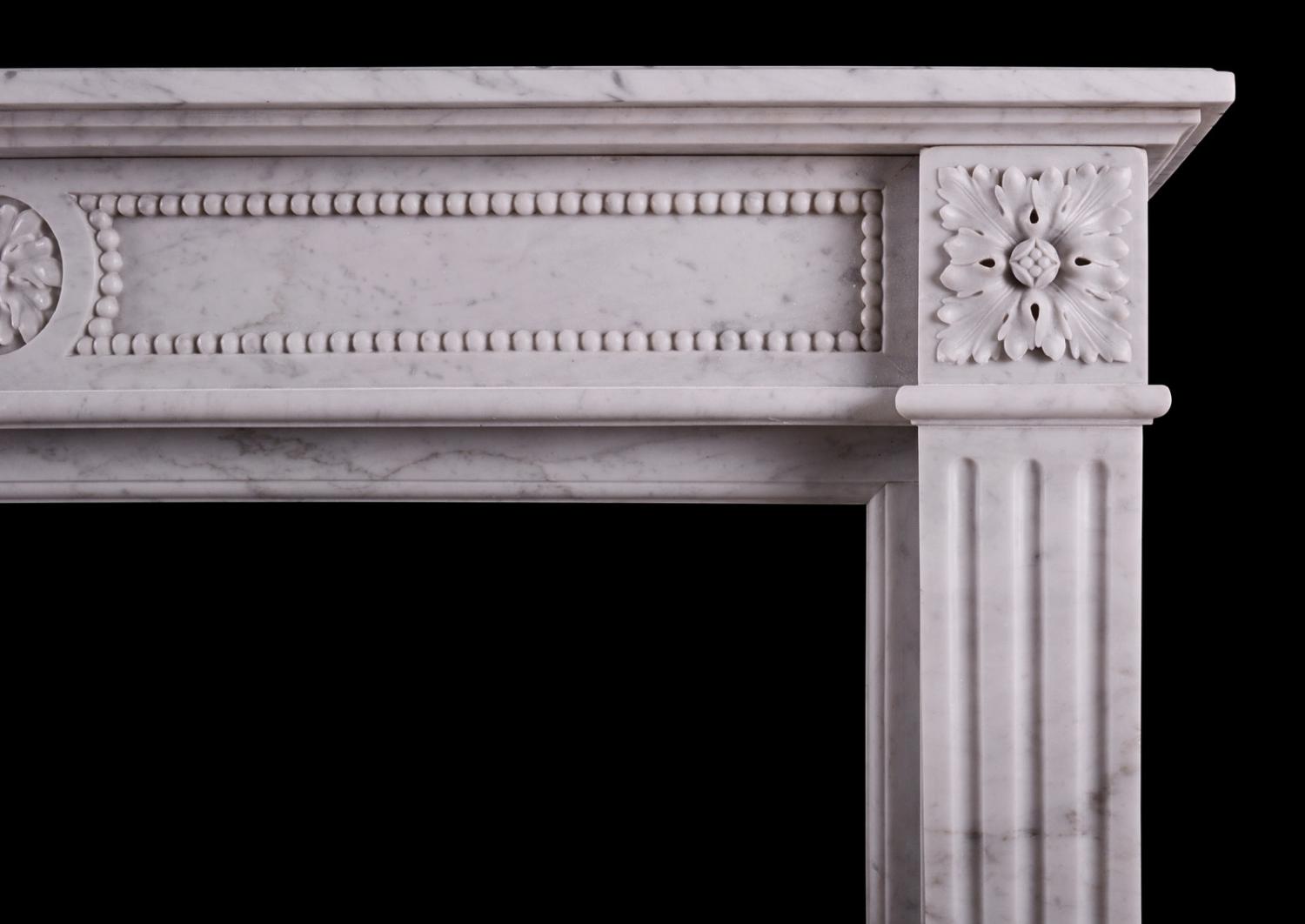 A petite French marble fireplace in the Louis XVI manner