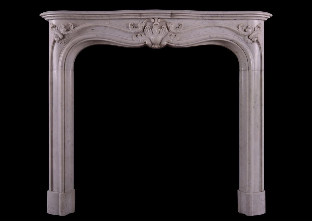 A French marble fireplace in the Louis XV manner.