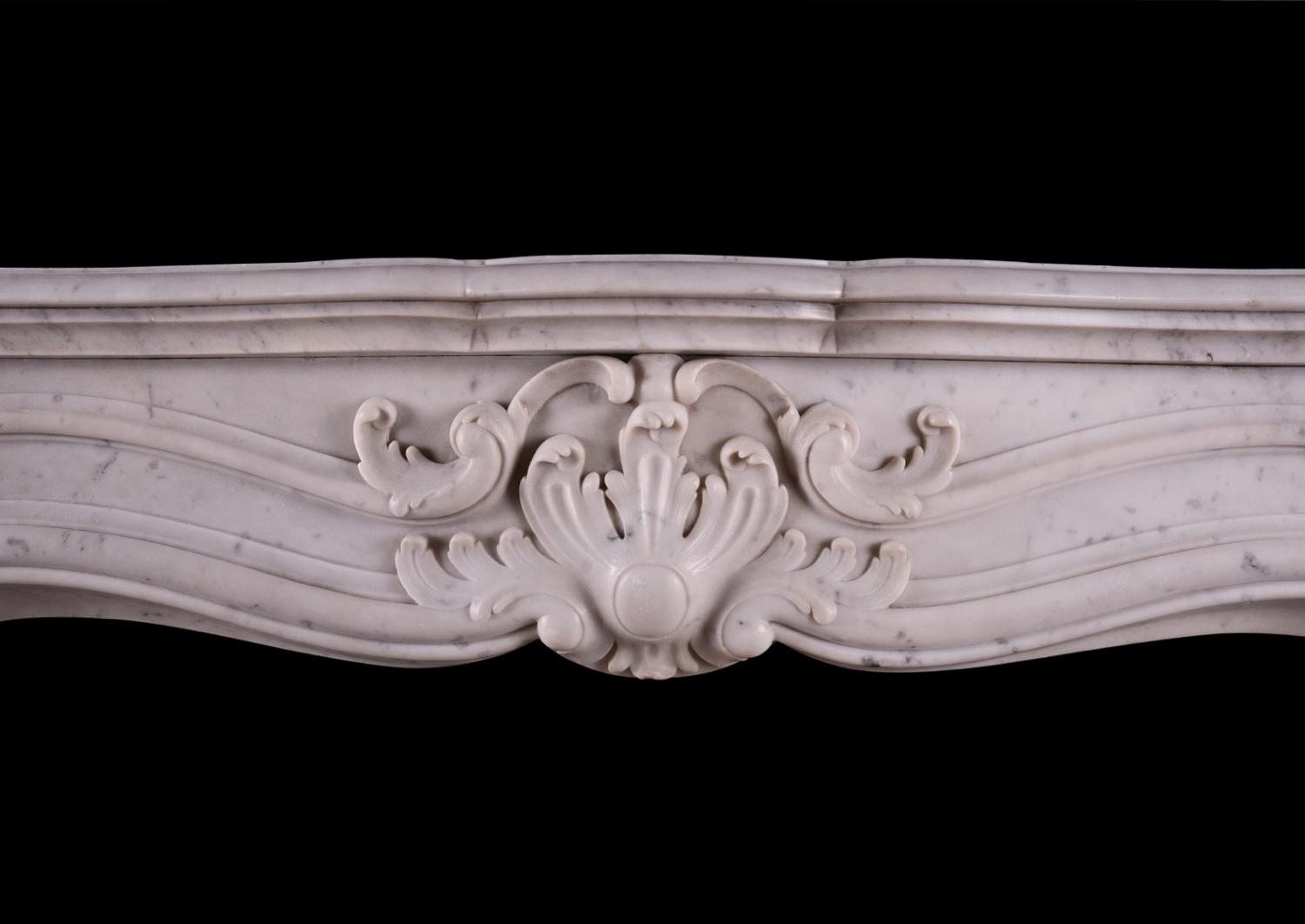 A French marble fireplace in the Louis XV manner.