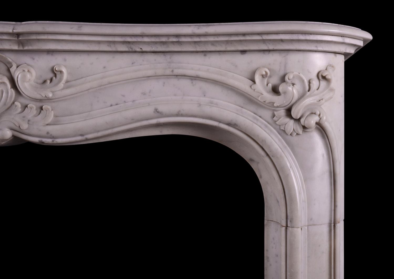 A French marble fireplace in the Louis XV manner.