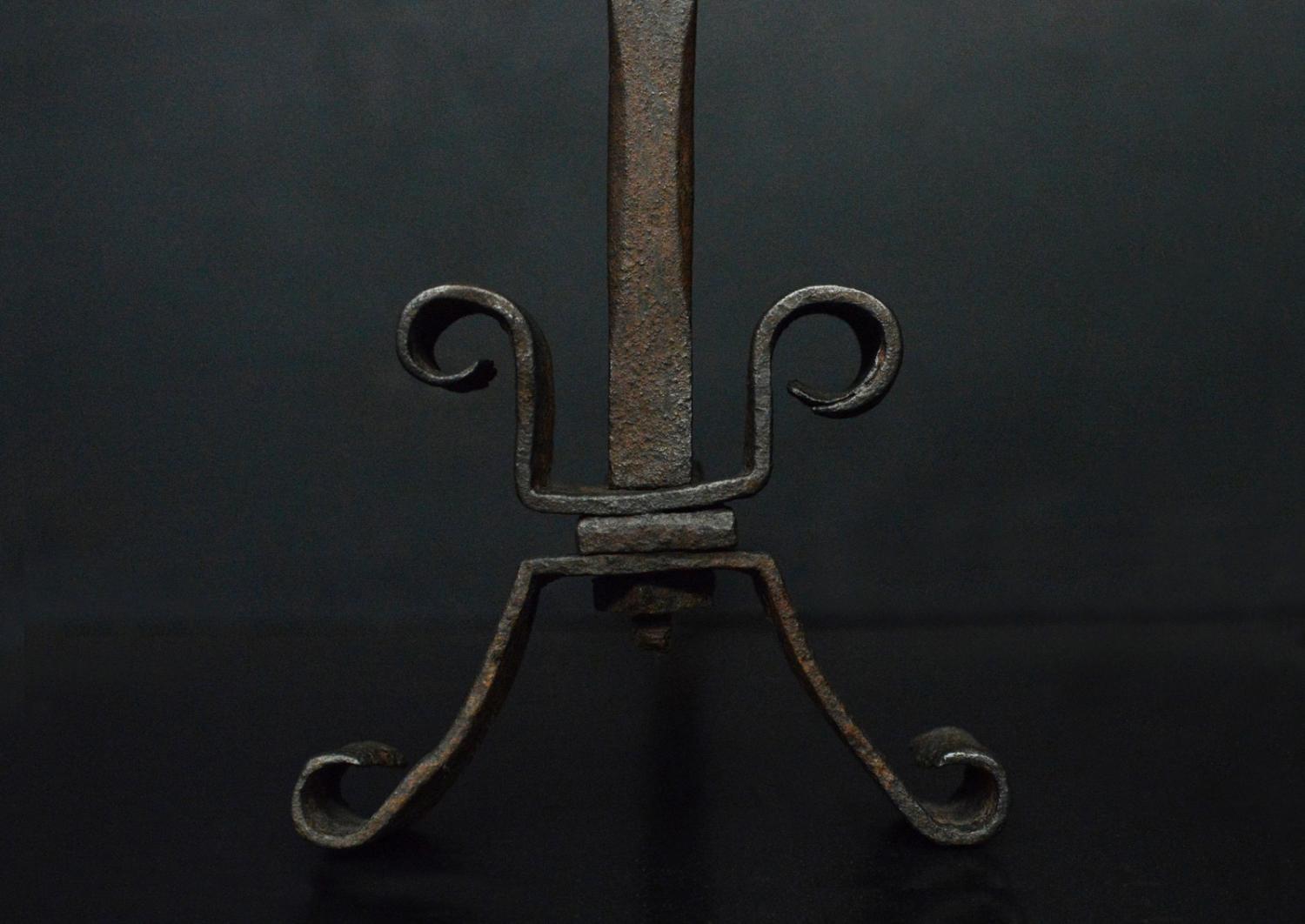 A pair of wrought iron firedogs