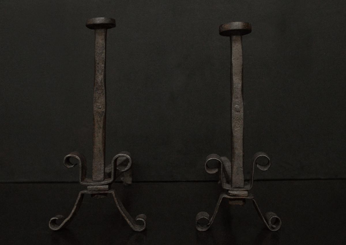 A pair of wrought iron firedogs
