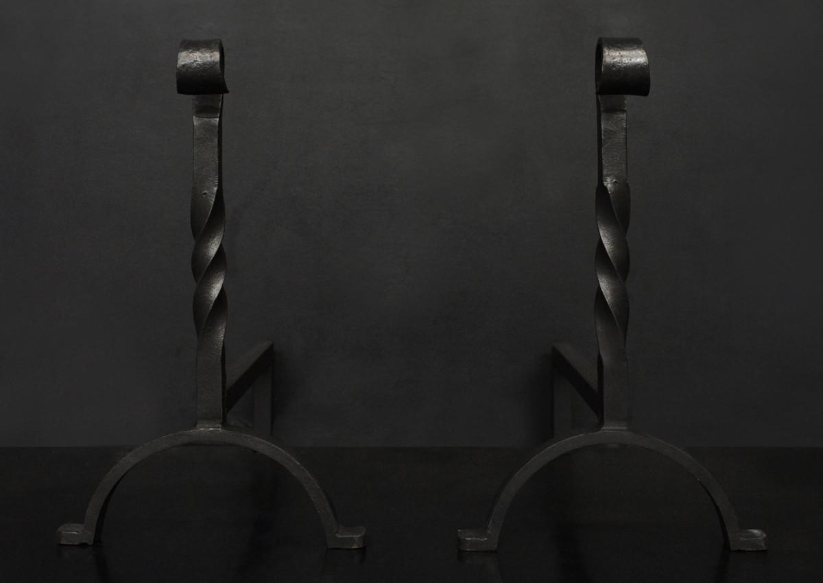 A pair of wrought iron firedogs