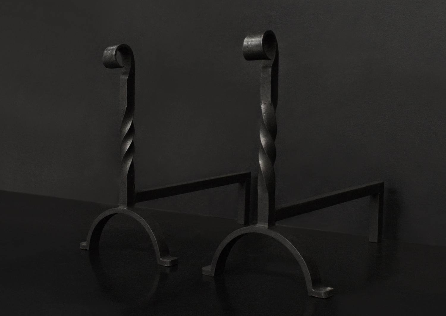 A pair of wrought iron firedogs