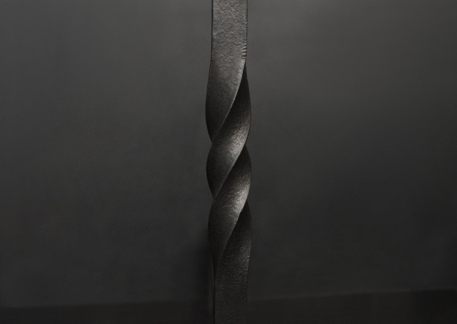 A pair of wrought iron firedogs