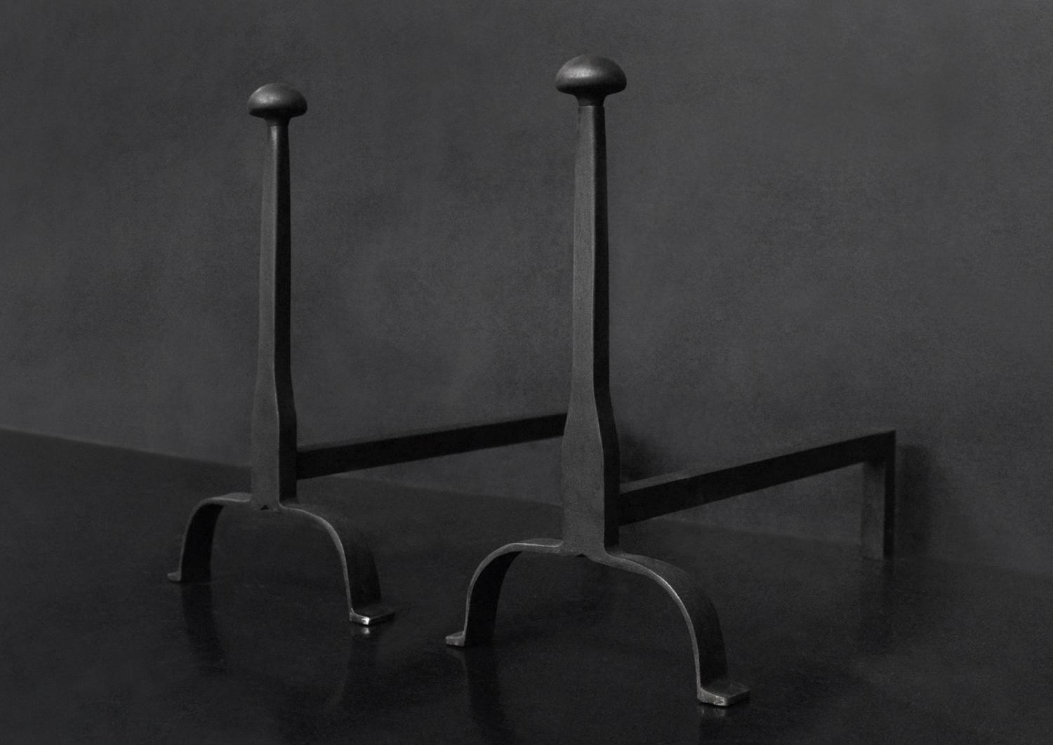 A pair of firedogs in black lead