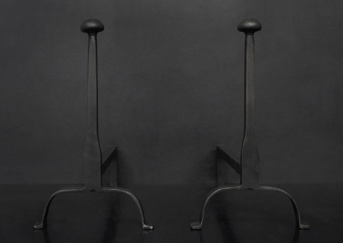 A pair of firedogs in black lead