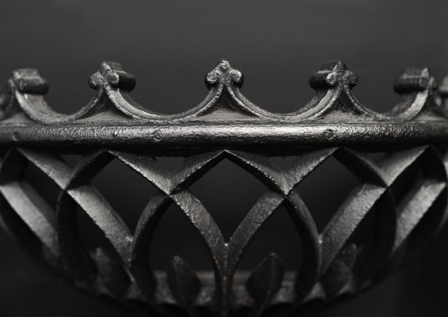 A bowed wrought iron firegrate