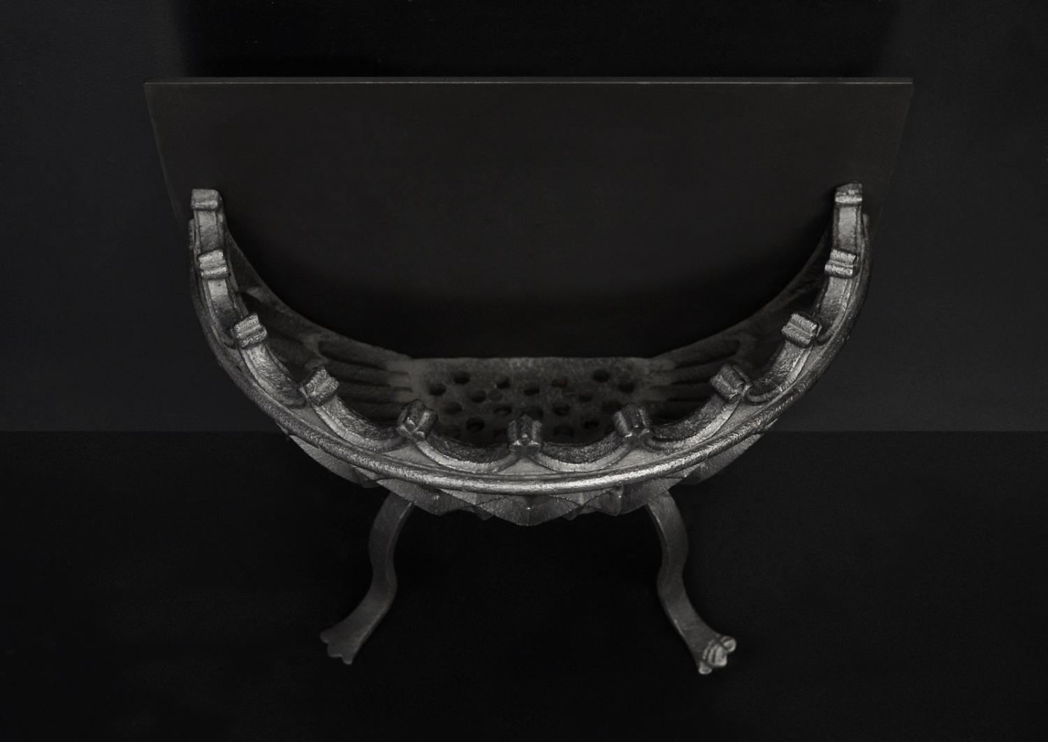 A bowed wrought iron firegrate