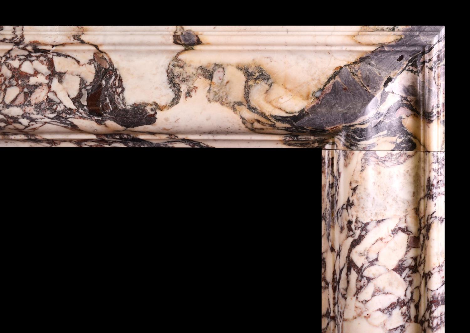A Breche Violette marble bolection fireplace